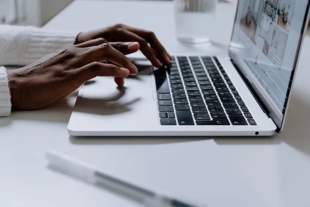 Hands typing on a sleek laptop keyboard, illustrating modern technology in use. Sending different follow-ups to attendees and no-shows